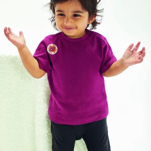 A child is standing in the image, dressed in a purple t-shirt and black pants. The background is white, and the child is smiling.