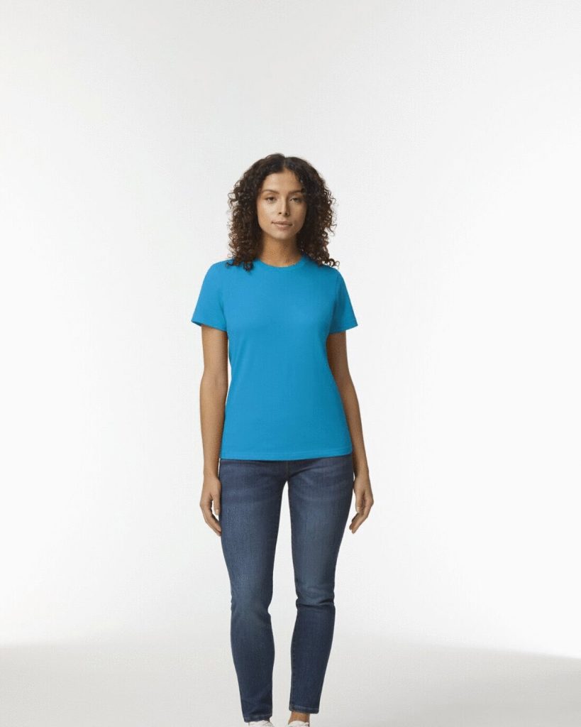 A woman is standing in the image, dressed in a blue t-shirt and blue jeans. The background is white.