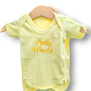 A yellow baby vest is depicted in this image, featuring the word "Hello World" written on it. The vest is hanging on a wooden hanger, and the background is white.