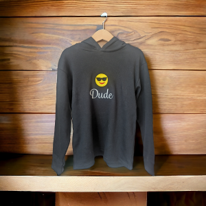 A black hoody is displayed in the image, featuring a white smiley face and the word "Dude." The hoody is hanging on a wooden surface.