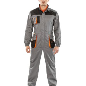 A man is standing in the image, dressed in a grey coverall with orange accents. The background is white.