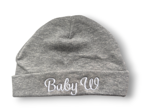 A grey beanie hat is the central focus of this image, with the word "BabY W" embroidered on it. The background is white.