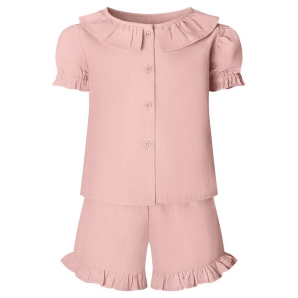 A child is depicted in this image, wearing a pink dress and a matching pink top. The top features a design with ruffles, while the bottom showcases a short, ruffle-covered top.
