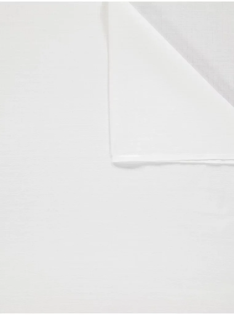 A white cloth is the central focus of this image, with a few white lines visible on its surface. The background is white as well.