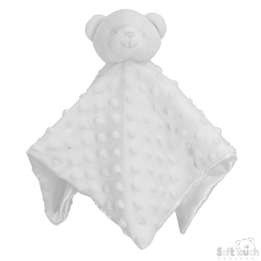 A white bear is depicted on a bed, resting on a white blanket. The blanket features a white color scheme, and the bear is white as well. The image is taken from a top-down perspective.