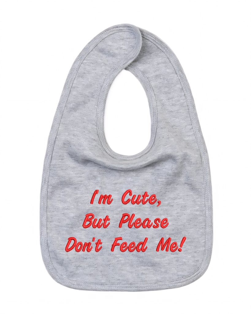 A grey-colored bib is depicted in this image, featuring a red and white design. The bib reads "i'm cute, but please don't feed me! " in red letters.