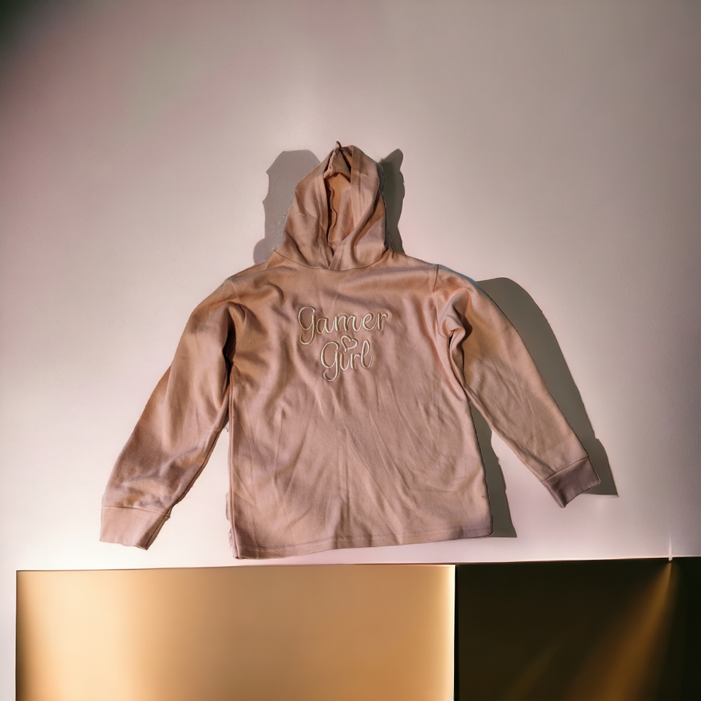 A hoodie is depicted in this image, featuring the name "jamper girl" written on it. The hoodie is cream in color and appears to be made of cotton.