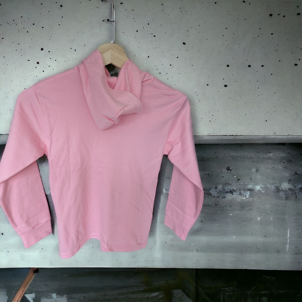 A pink hoodie is displayed in the image, hanging on a hanger. The background features a grey wall.