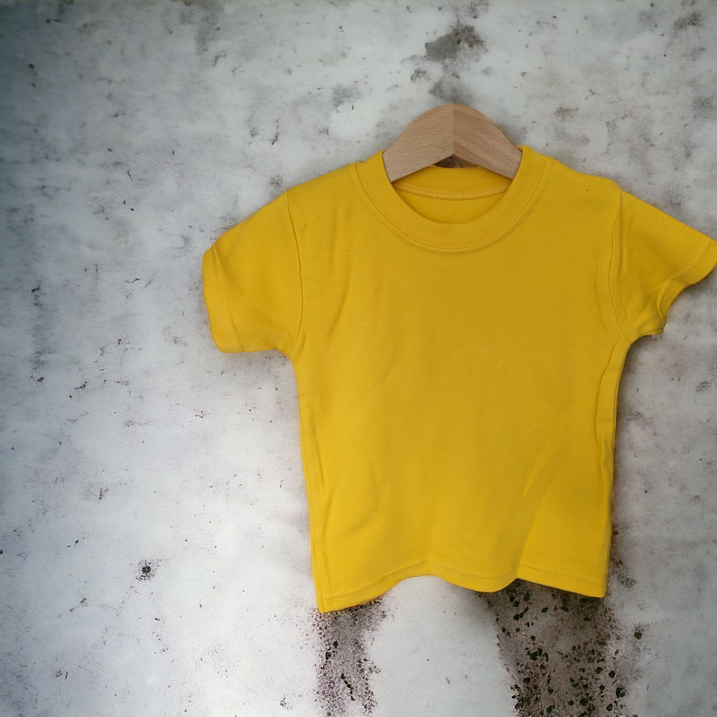 A yellow t-shirt is displayed in the image, hanging on a wooden hanger. The background features a white wall.