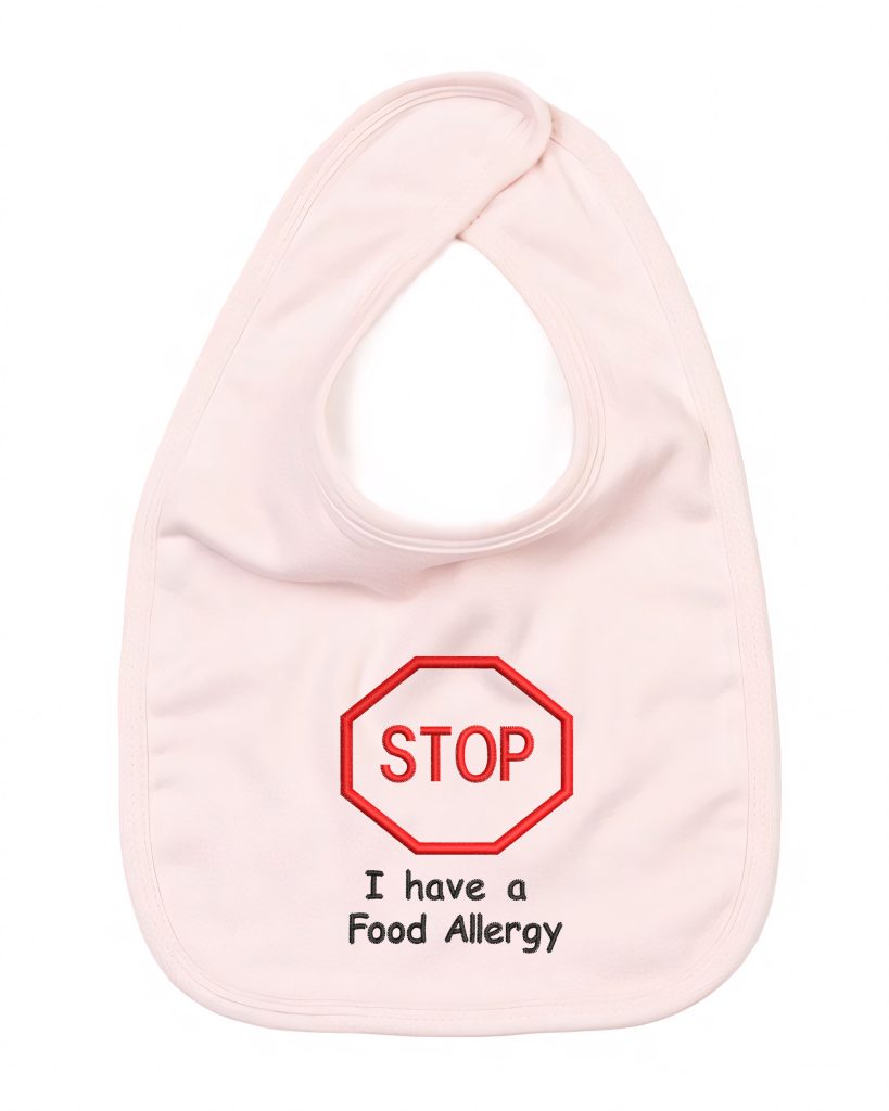 A pink-colored bib is depicted in this image, featuring a red word "stop" written on it. The background is white, and the image is taken from a top-down perspective.