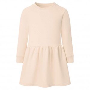 A child is depicted in this image, wearing a cream-colored dress. The background is white, and the image appears to have been taken in a studio setting.