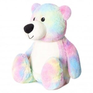 A colorful teddy bear is the central focus of this image, with a white and cream background. The bear is adorned with a blue, pink, and yellow color scheme.