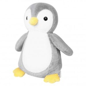 A stuffed penguin toy is the main focus of this image, with a white background. The toy is placed on a white surface, and a yellow object is also visible in the image.