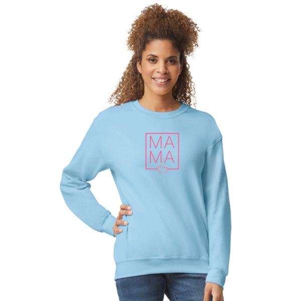 A woman is standing and smiling in the image