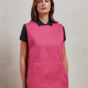 A woman is standing in the image, dressed in a pink tabard, black t-shirt, and black pants. The background is a cream-colored wall.