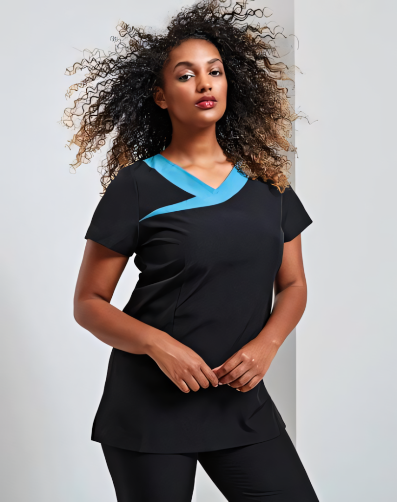 A woman is standing in the image, dressed in a black tunic with blue accents. She is smiling and posing for the camera. The background is white.