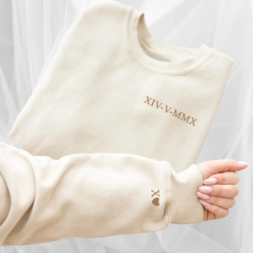 A white sweatshirt is displayed in the image