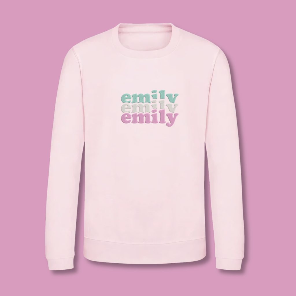 A pink sweatshirt is displayed in the image