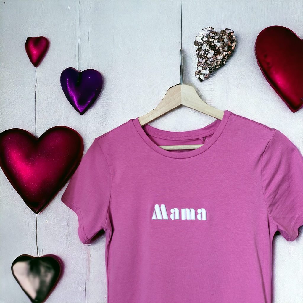 A pink t-shirt is displayed in the image