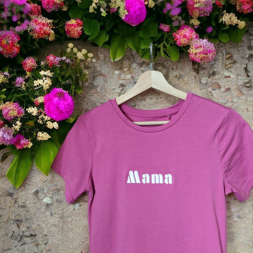 A pink t-shirt is displayed in the image