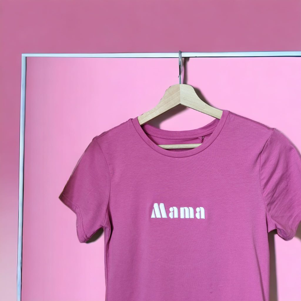 A pink t-shirt is displayed in the image